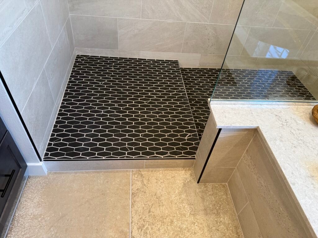 Modern walk in shower with step. Beautiful tile work with metal edging and glass wall. Rancho Bernardo Poway Scripps Ranch Rancho Santa Fe Fairbanks Ranch